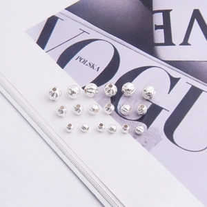 Close-up of three sizes of faceted S925 sterling silver beads for DIY jewelry making