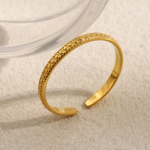Minimalist 18K gold plated beaded open ring with textured dots on beige surface