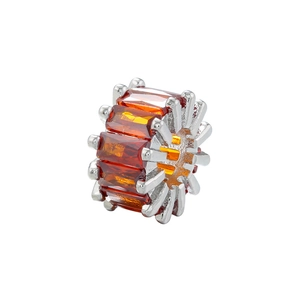 Macro shot of silver plated barrel bead with orange rectangular zirconia for DIY jewelry