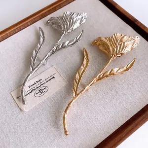Elegant heavy metal tulip flower brooch with textured pleats in gold and silver finish