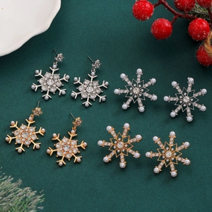 Sparkling snowflake earrings with rhinestones and pearls in festive Christmas scene