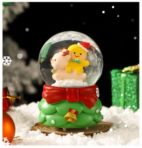 Detailed Christmas snow globe featuring gingerbread man, reindeer, and festive tree base