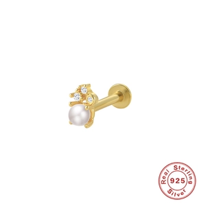 Detailed macro view of 925 sterling silver ear stud with three diamonds and a white pearl