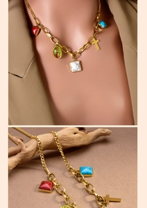 Close-up of gold layered necklace with vintage pendants and turquoise stone on wooden decor