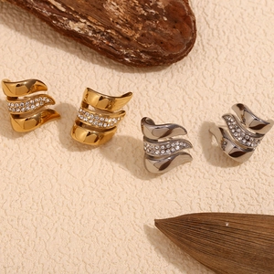 Detailed view of layered wavy gold and silver ear cuffs with pavé set cubic zirconia