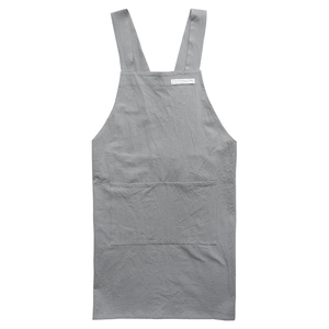 Grey linen apron with wide shoulder straps and a central pocket on white background