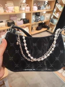 Black quilted shoulder bag with bow embroidery, pearl handle and star chain strap