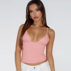 Detail of pink deep V-neck camisole with pleated fabric and slim fit style
