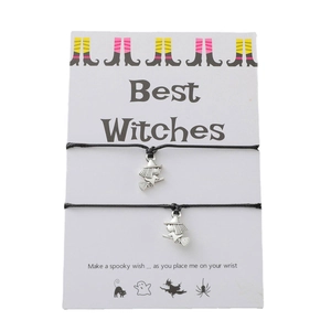 Halloween Best Witches cord bracelets set with metal charms on a spooky themed gift card