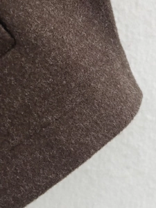 Macro shot of dark brown wool fabric texture with soft brushed fuzzy surface detail