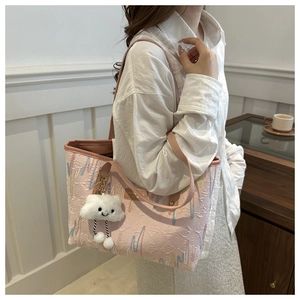 Pink tote bag detail with wave patterns and white cloud plush charm on long strap