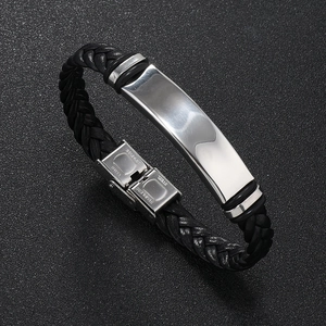 Detailed shot of braided leather strap and polished stainless steel clasp on male bracelet