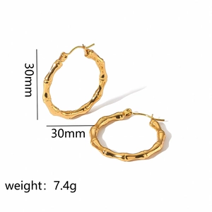 Detail of 30mm golden bamboo textured hoop earrings weighing 7.4g in stainless steel