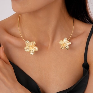 Eleganter goldener Blumen-Halsreif mit metallischer Textur am Hals eines weiblichen Models