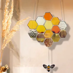 Acrylic honeycomb suncatcher with yellow hex tiles and small bee pendant for window decor