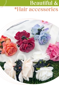 Detail view of five assorted colorful 3D rose flower hair claws on fabric and grass background