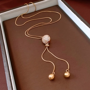 Macro shot of 18K gold plated snake chain with a sparkling pavé zircon ball pendant