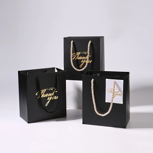 Elegant black gift paper bags with gold Thank You lettering and woven rope handles