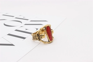 Gothic skull ring featuring a red coffin center and relief skeleton band details