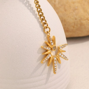 Detailed macro view of 18K gold plated North Star pendant with shimmering cubic zirconia