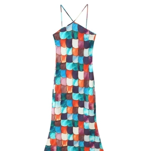 Detail of colorful fish scale print dress with elegant crisscross back straps