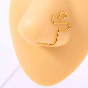 Macro detail of a golden wave-shaped non-piercing nose clip on a silicone model