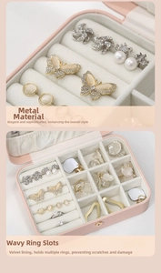 Detail of pink jewelry box featuring soft velvet lining and wave ring storage slots