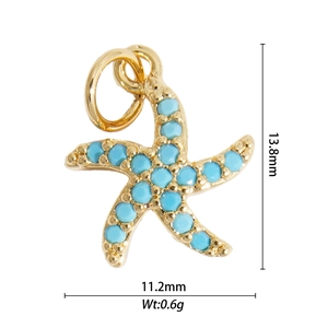 Macro shot of gold starfish charm with turquoise stone and dimensions 13.8mm by 11.2mm