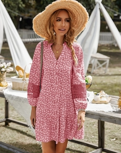 Close-up of pink floral dress featuring delicate hollow lace patchwork on the short sleeves