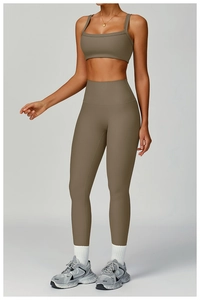Detail of high waist ribbed yoga pants and sports bra showing knit fabric texture