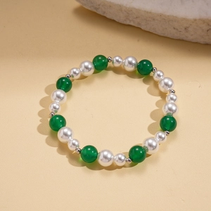 Close-up of beaded bracelet with white faux pearls, green agate beads and silver spacers