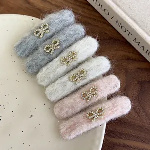 Set of six plush hair clips with rhinestone bows in grey, beige, and pink colors