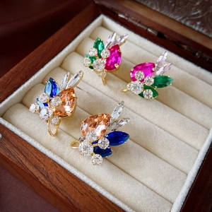 Elegant vintage gold drop earrings with colorful teardrop crystals in luxury jewelry box