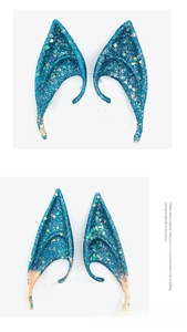 Detail of blue glitter elf ears for Halloween cosplay featuring shiny hexagonal sequins