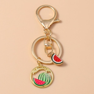 Creative gold keychain featuring realistic watermelon fruit slices and lobster clasp charms