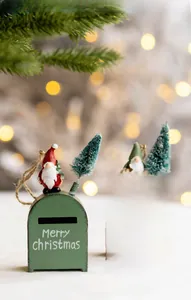 Close-up of red and green Christmas mailbox ornaments with gnomes and miniature trees