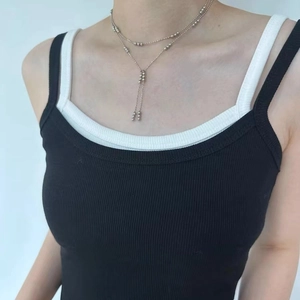 Minimalist silver beaded tassel double layer necklace set shown on a model neck