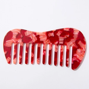 Portable red and white marble texture acetate wide-tooth comb for wavy hair on white background