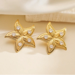 Elegant gold starfish stud earrings with sparkling cubic zirconia in a minimalist style