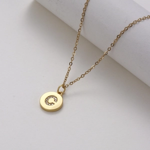 Golden stainless steel necklace with round pendant featuring a zircon letter C design