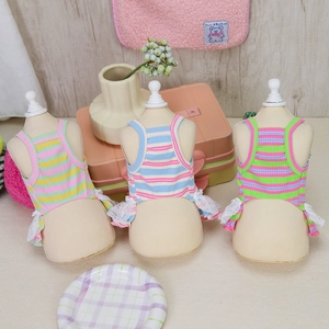 Detailed view of colorful striped pet sundresses with delicate white lace trim on skirts