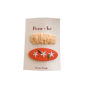 Orange floral embroidery and pleated fabric oval BB hair clips set on display card