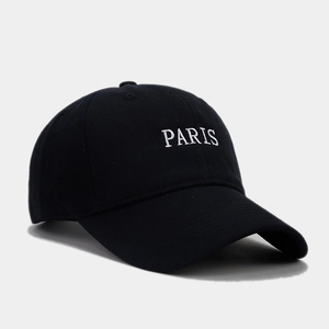 Detail shot of white PARIS embroidery on premium black cotton twill baseball cap