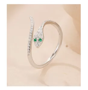 Close-up of S925 silver snake ring with pavé white zircons and green gemstone eyes