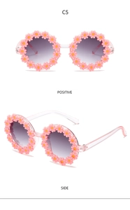 Pink daisy kids sunglasses with gradient purple lenses, shown in front and side views