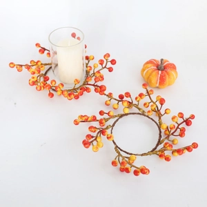 Orange berry wreath candle rings with miniature pumpkins for Thanksgiving table decor