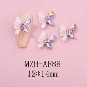Detailed macro view of 12x14mm resin butterfly nail charms with iridescent rhinestones