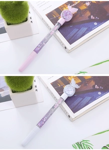 Close-up of sparkling liquid sand pens with butterfly charms and glitter-filled barrels