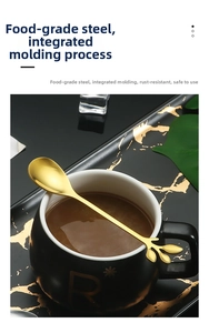 Detail of leaf-shaped stainless steel spoon across a coffee cup with food-grade steel texture