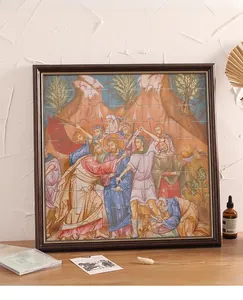 Detail of classic religious oil painting puzzle inside a vintage dark wood frame on a desk